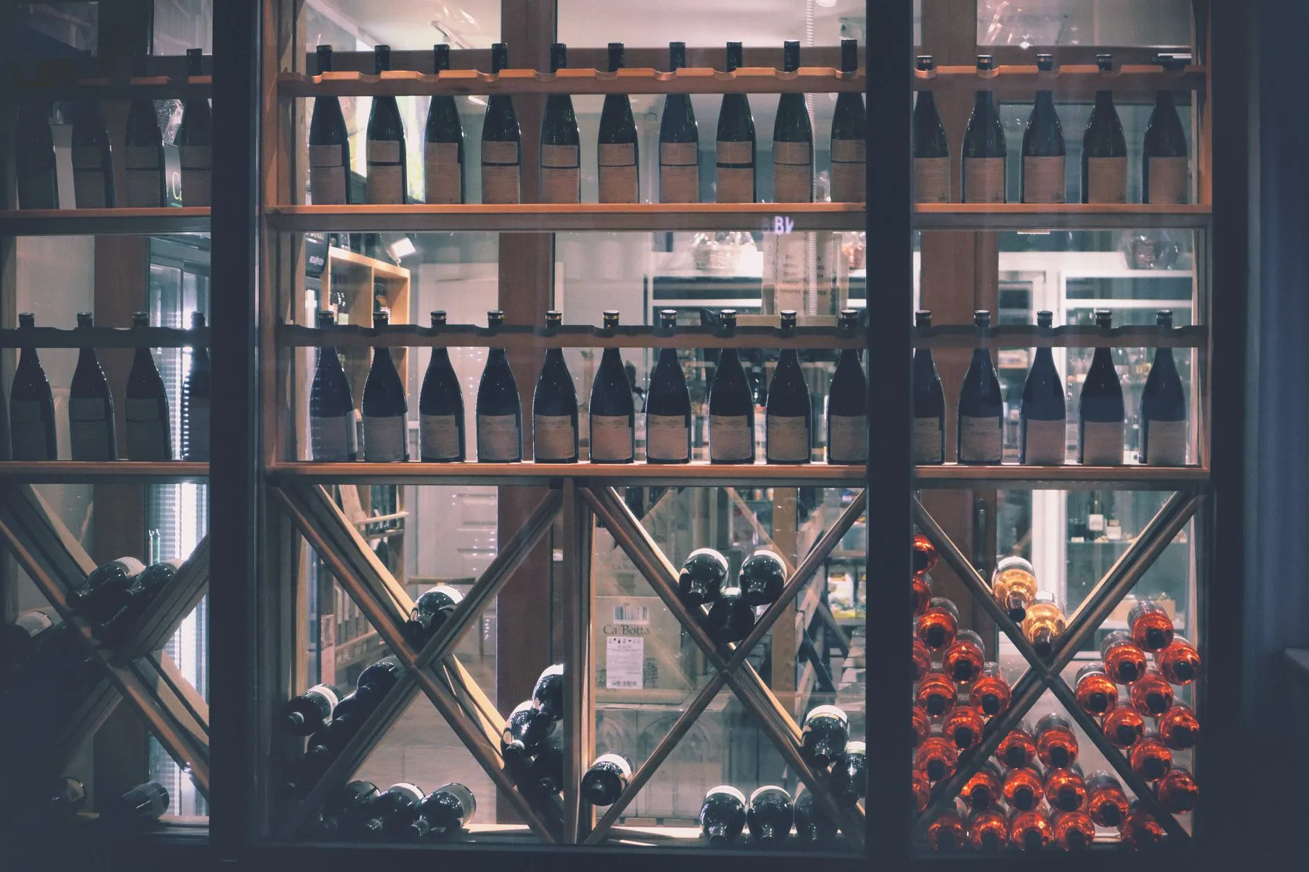 A beautifully arranged wine display in a market setting, featuring diverse bottles.
